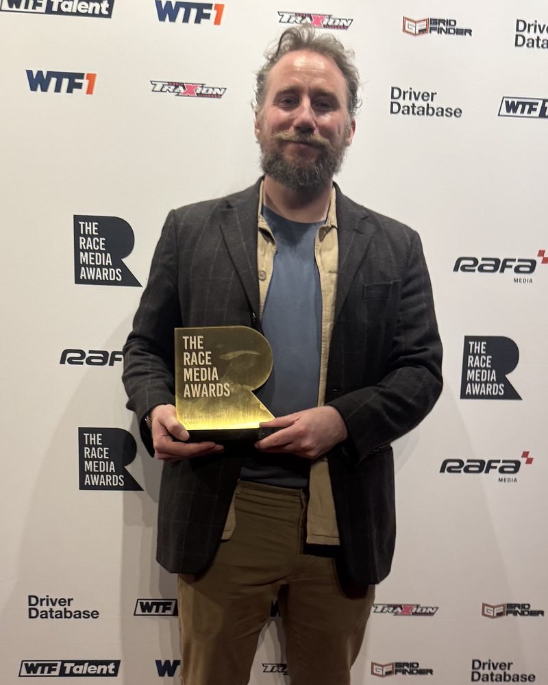 Dave Ellis holding The Racing Line's Brand of the Year trophy at the 2026 Race Media Awards